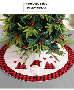 Detailed embroidery of a Christmas gnome and buffalo plaid trees on a plush white tree skirt