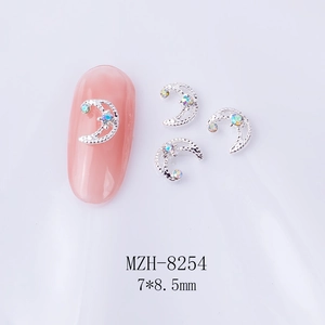 Macro view of moon-shaped nail art alloy with crystal rhinestones sized 7x8.5mm