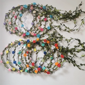 Detailed overhead view of assorted floral crowns with colorful fabric roses and leaves