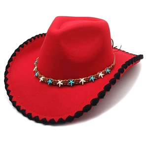 Detail of red cowboy hat with black scalloped edge and ethnic woven band decoration