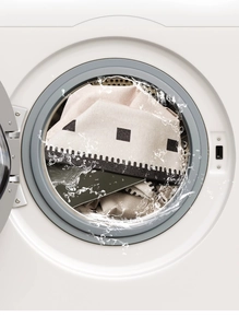Close-up of machine washable chenille rug being cleaned inside a washing machine drum
