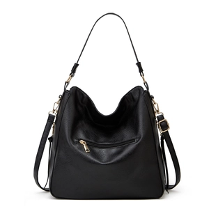 Detail of black PU leather tote with gold-tone hardware and adjustable shoulder strap