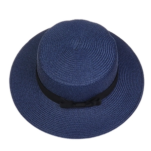 Top view of deep blue straw hat with wide brim and elegant black ribbon decoration