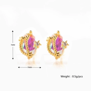 Detail of 18K gold star and moon stud earrings with a pink gradient crystal stone