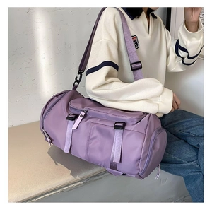 Detail of purple nylon fitness bag with adjustable shoulder strap and side zipper pocket
