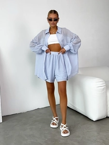 Close-up of light blue striped texture on casual summer shirt and matching shorts set