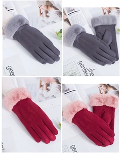 Detail of suede winter gloves for women featuring plush fur cuffs and decorative stitching