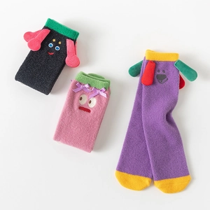 Detailed view of three colorful thick coral fleece socks with 3D cartoon animal ears