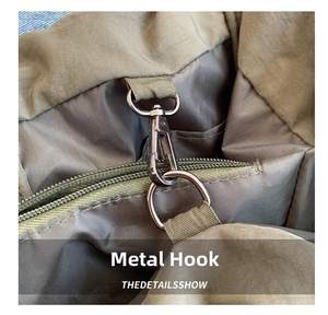 Detailed close-up of heavy-duty metal swivel hook and zipper on olive nylon bag