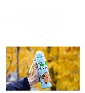 Close-up of a blue Capybara cartoon water bottle featuring a portable carry strap