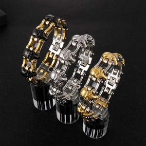 Detailed view of skull bicycle chain bracelets in black gold, silver, and dual-tone steel