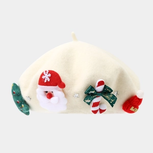 Detailed view of cream wool beret featuring festive Santa, Christmas tree, and candy cane