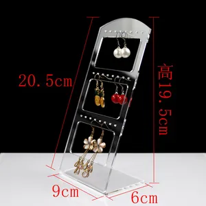 Macro view showing dimensions of tiered acrylic earring stand with jewelry hangers