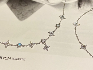 Macro shot of silver clover bracelet with sparkling zircons on Madame Figaro magazine