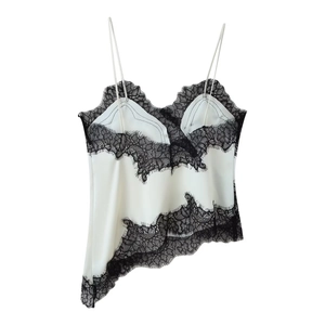 Detailed view of white satin camisole top with black lace trim and delicate stitching