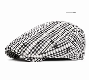 Detail shot of the gray checkered pattern and fabric texture of the flat newsboy cap