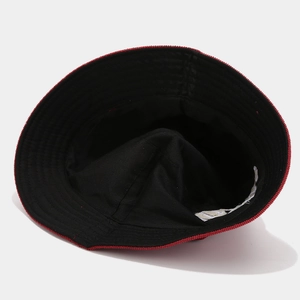 Close-up of inner lining and stitching on black corduroy bucket hat with red trim