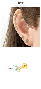 Macro view of 3mm titanium clover ear stud with blue zircon inlay and threaded post