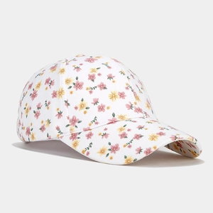 Close-up of pink and yellow floral pattern on white canvas cotton baseball cap