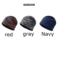 Detailed color display of thick knit beanies in red, gray, and navy mixed yarns