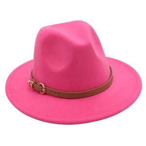 Detail view of pink fedora hat with wide brim featuring a brown leather decorative band