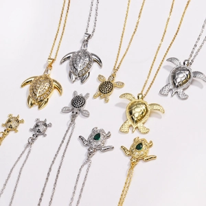 Detailed view of turtle pendants featuring sparkling gemstones in gold and silver finishes