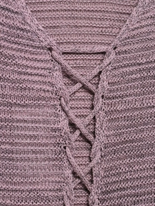 Detail of purple knitted sweater featuring cross-lace neckline and thick knit texture