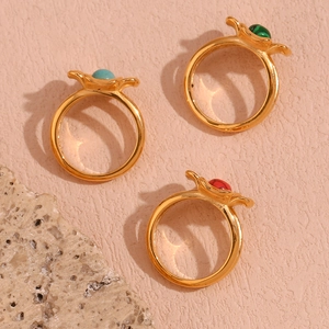 Detailed macro view of 18K gold plated flower rings with colorful inlaid stones