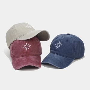 Washed retro baseball caps with sun embroidery in grey, burgundy, and dark blue colors