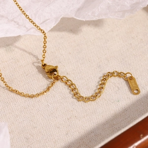 Close-up of 18K gold plated stainless steel necklace chain with K18 hallmark tag