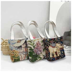 Three embroidered canvas handbags featuring sunflower, lilac, and elephant patterns
