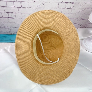 Inside detail of women's straw sun hat with sweatband and elastic wind rope