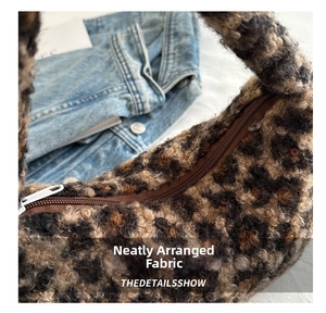 Macro detail of high-quality zipper and leopard print faux fur texture on a shoulder bag