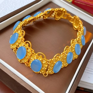 Close-up of vintage gold flower necklace with blue gems in a premium brown jewelry box