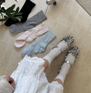 Detailed view of hollow floral pattern on breathable cotton crew socks for women