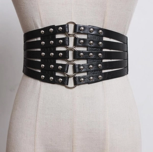 Punk style wide black corset belt with five metal rings and crocodile pattern on mannequin