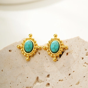 Vintage oval turquoise stud earrings with 18K gold plating on a textured stone surface