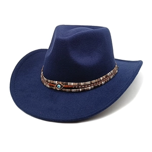 Detailed shot of navy felt fedora featuring woven band and evil eye metal ornament
