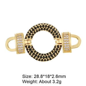 Macro shot of gold-plated connector with black and clear cubic zirconia gemstones