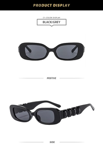 Detail view of black square sunglasses with crystal embellishments and grey lenses