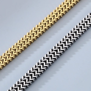 Macro shot of gold and silver woven metal chains with distinctive snake head texture