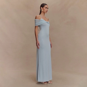 Close-up of a light blue halter maxi dress featuring a twisted knot detail and soft pleats