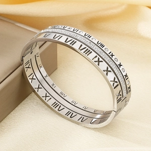 Detail of silver titanium steel bracelet with roman numerals and sparkling crystals
