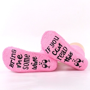 Pink coral fleece sleep socks featuring anti-slip letter print with wine text design