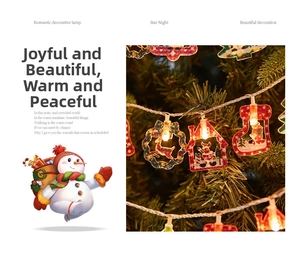 Detail of warm LED Christmas string lights with Santa and reindeer hanging ornaments