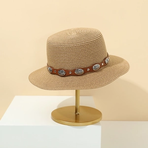 Women's summer straw boater hat with studded leather band on elegant display stand