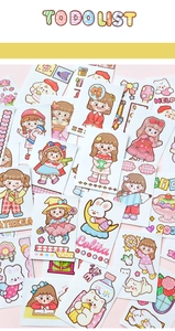 Detailed spread of cute cartoon stickers with girl, rabbit, and bear motifs for journaling