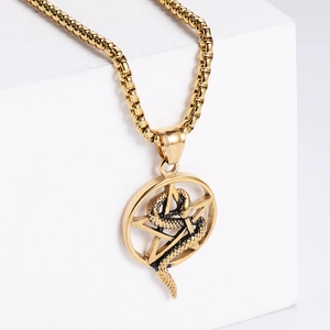 Minimalist gold stainless steel necklace with star and snake pendant on white pedestal