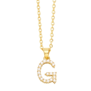 Detailed macro view of gold letter G pendant inlaid with elegant white faux pearls