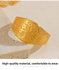Macro shot of 18k gold plated Tree of Life relief ring with vintage textured details
